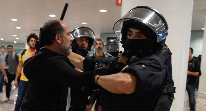 La policía de Cataluña desaloja a manifestantes del aeropuerto El Prat en Barcelona. (AFP / Josep LAGO).